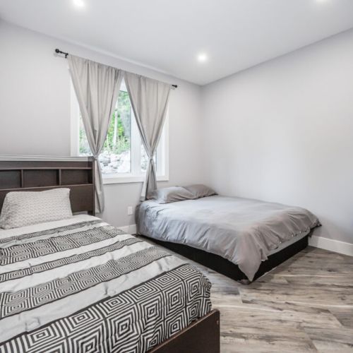 Guest Room B features two double beds with a direct view of the escarpment ridge-line.