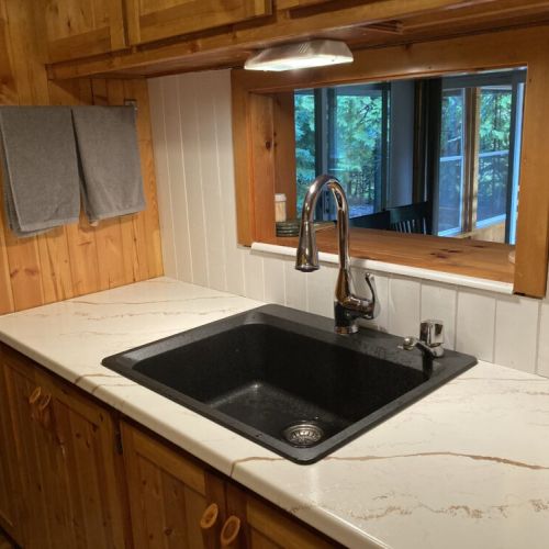 Large kitchen sink with a serving window to the dining room.