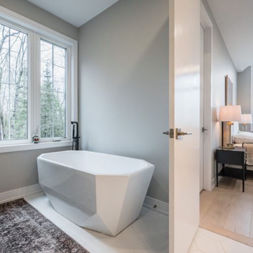 Indulge in the ultimate pampering experience with the master bedroom's ensuite bathroom. Discover a freestanding tub as its centerpiece, offering a tranquil escape and a touch of spa-like luxury, complemented by high-end fixtures and finishes.