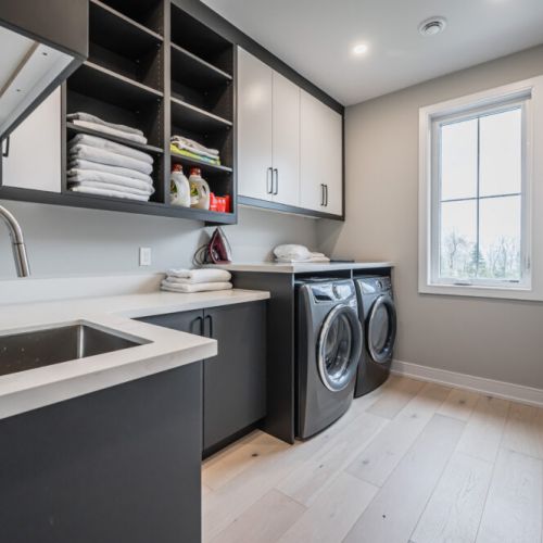 The laundry area is designed to be spacious and well-lit, creating a comfortable environment for guests to tackle their laundry tasks. Ample counter space is available for folding clothes and organizing laundry items.
