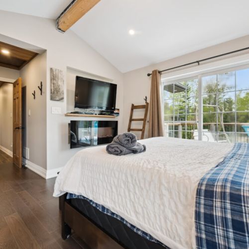 Enjoy a cozy and spacious room featuring an electric fireplace, along with a DVD player and Apple TV remote for your entertainment.
