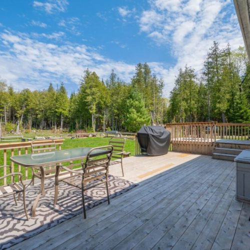 The patio is perfect for enjoying the outdoors, with plenty of patio furniture and a BBQ for grilling.