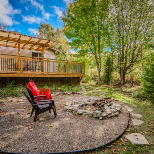 Gather around the fire pit with friends and family, enjoy the warmth of a crackling fire, and take in the peaceful wooded surroundings.