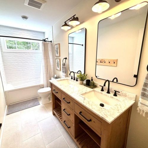 Modern luxury – enjoy this elegant bathroom with dual sinks, granite counters, and plenty of space for morning routines or winding down at night.