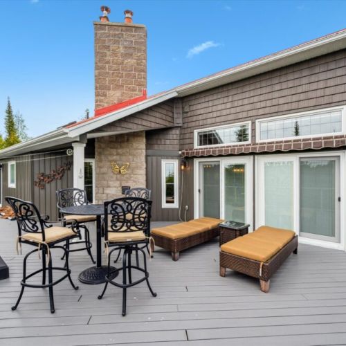 A true lake lover’s lounge! This upper-level deck features plenty of seating, a BBQ zone, and panoramic views of the surrounding forest and water—sunsets are a must-see.