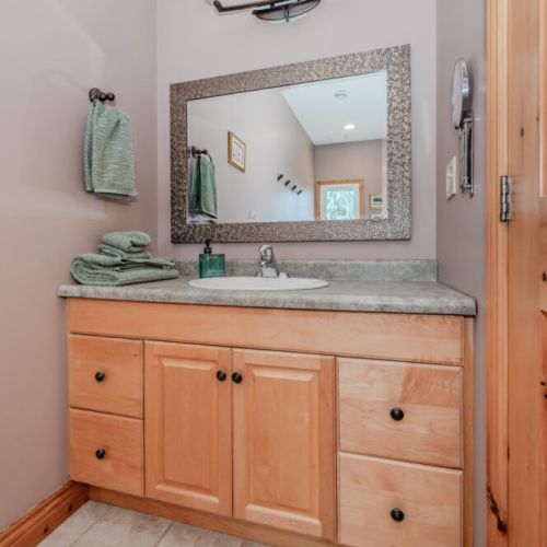 Clean, well-lit bathroom with plush towels and full amenities—adding comfort to your relaxing stay.