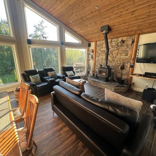 Couch converts to a comfy queen bed to cozy up by the wood burning stove and watch Apple TV options. Additional Bedding available upon request.