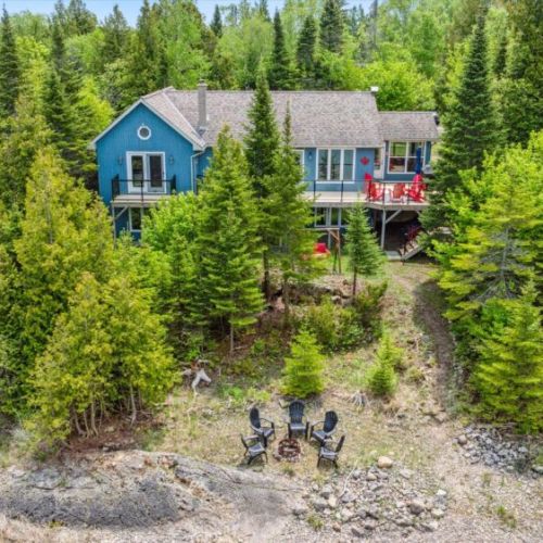 A private, tree-lined retreat just steps from Myles Bay, offering the perfect blend of seclusion and lake access.