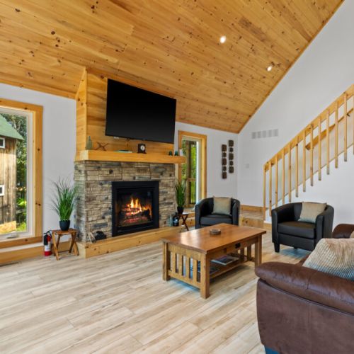 Soaring cathedral ceilings and a stunning fireplace create the perfect cottage atmosphere.