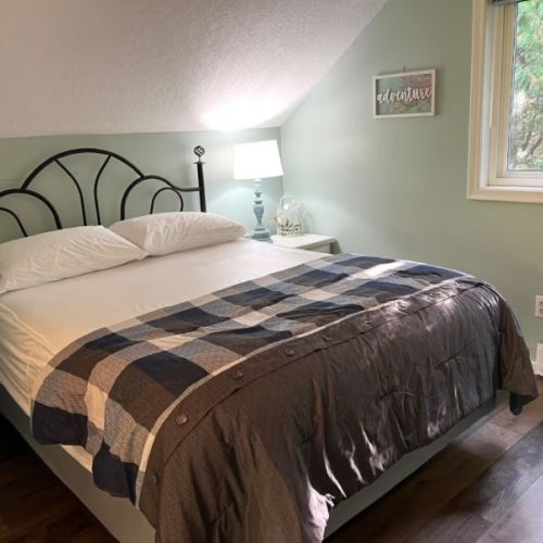 Relax in comfort after a day exploring the Bruce Peninsula. Fresh linens, a cozy quilt, and tranquil views make this space perfect for rest and rejuvenation.