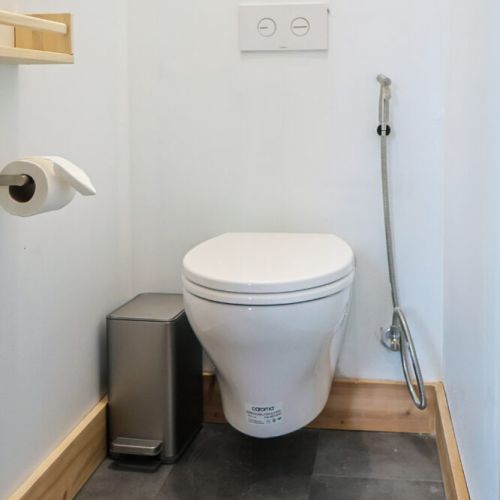 Stylish and Functional: This bathroom boasts a stylish design with a wall-mounted toilet and sensor lighting. The minimalist aesthetic and functional features create a comfortable and convenient space.