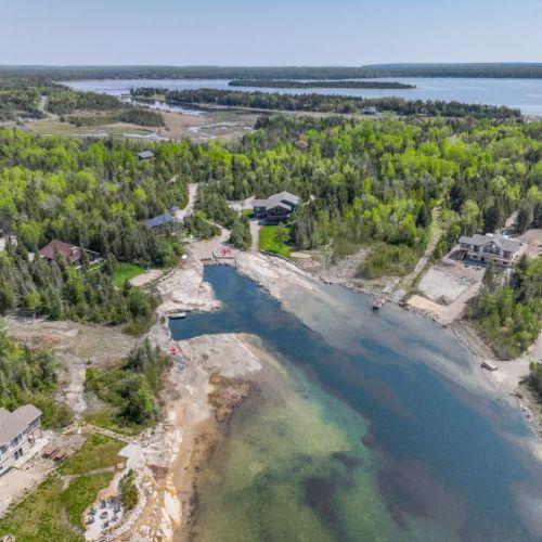 A picturesque setting with clear water, sandy shores, and lush greenery, offering a perfect retreat from everyday life.