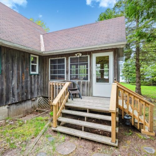 Step inside through the side entrance, where natural wood textures and large windows offer a warm welcome into your home away from home.