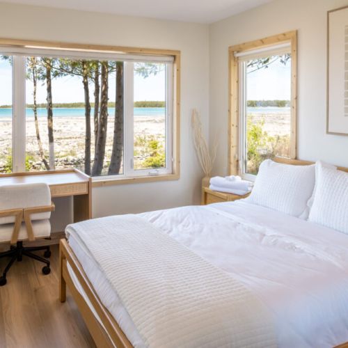 Wake up to breathtaking views of Lake Huron from the comfort of your queen-size bed. This spacious bedroom also features a dedicated workspace, perfect for those who need to stay connected while away from work.