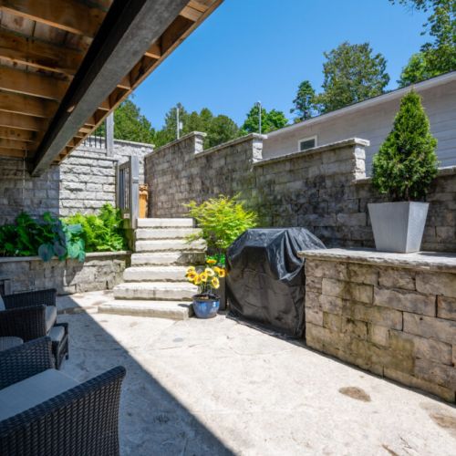 Secluded outdoor space with BBQ and easy access to upper decks.