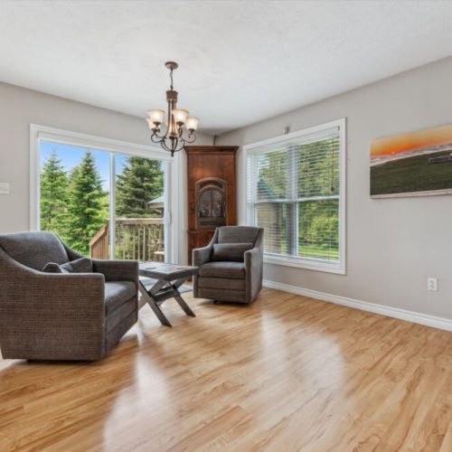 Cozy up in this bright sitting nook overlooking the trees — your go-to spot for morning coffee or a relaxing read.