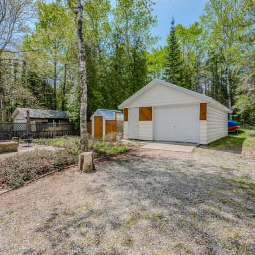 The garage and surrounding backyard offer plenty of space for outdoor activities and parking.