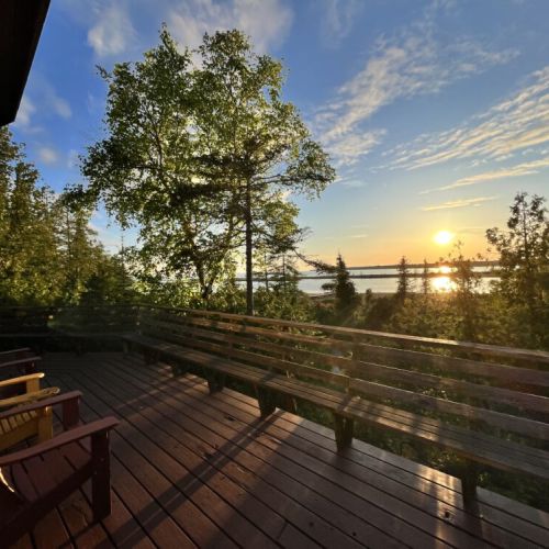 The sunny deck overlooking the waterfront at Silver Birch Cottage, perfect for relaxing and enjoying the scenic views.