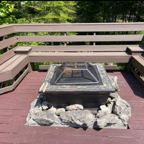 Unwind by the fire pit with built-in bench seating—perfect for stargazing, storytelling, and cozy cottage evenings.