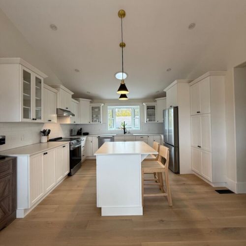 Bright, modern kitchen with a large island, top appliances, and plenty of space to cook and connect during your stay.