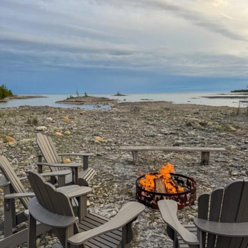 Unwind by the fire on the rocky shoreline with sweeping views of the lake. The perfect setting for sunsets, stories, and s’mores.