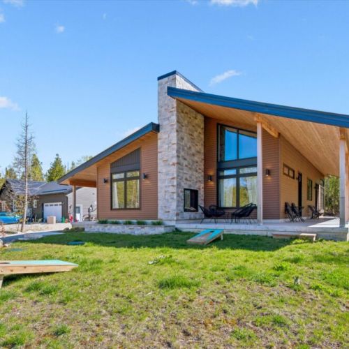 Striking modern design with soaring windows and warm natural finishes.