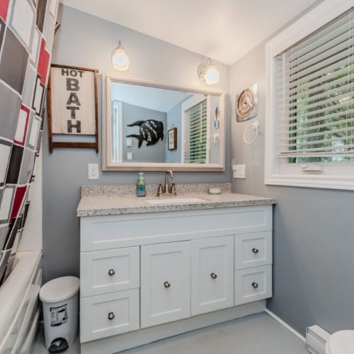 Enjoy a clean, updated bathroom with plenty of natural light and whimsical décor—ideal for a relaxing stay.