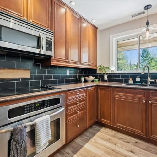 Cook with ease in the well-appointed kitchen featuring modern appliances, generous counter space, and everything needed for family meals.