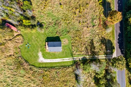 A bird’s-eye view of the private country setting, with a winding driveway leading to the homestead and plenty of green space to enjoy.