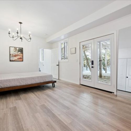 Spacious bedroom with clean design, soft natural light, and easy access to the outdoors. A calm, comfortable place to relax during longer stays.