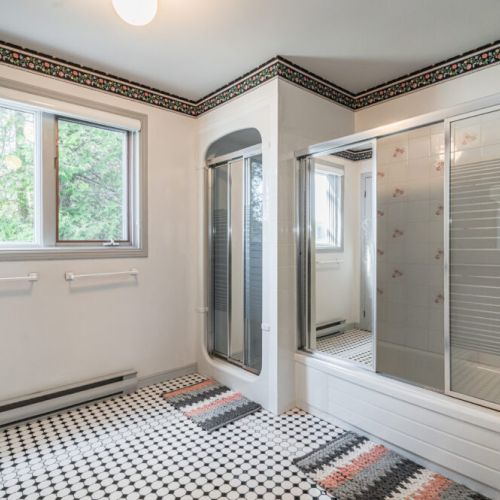 The spacious family bathroom includes a large vanity and plenty of natural light.
