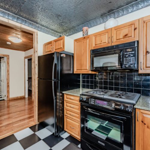 Fully equipped kitchen with warm wood finishes and modern appliances. Great for extended stays and self-catering at your country cottage.