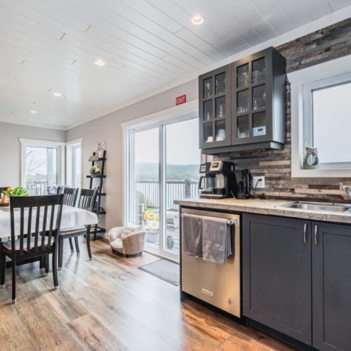 Open-concept kitchen with natural light and easy access to the dining area and deck.