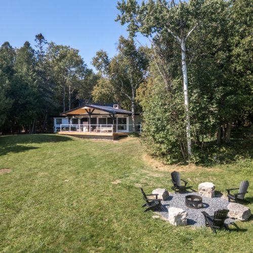 Fire pit circle tucked on the lawn for cozy evenings under the stars.