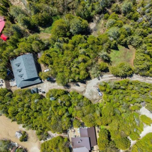 Bird’s-eye view of the spacious cottage property surrounded by natural landscapes and peaceful woodland scenery.