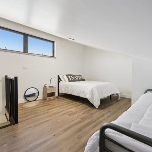 Spacious loft bedroom with extra sleeping space for families and groups.