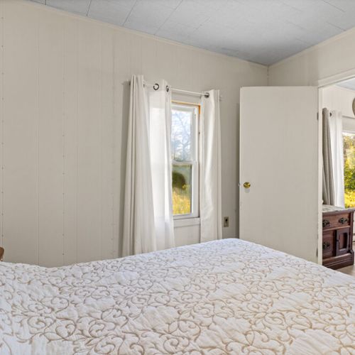 Wake up to peaceful country views and natural light from this comfortable main-floor bedroom.