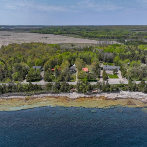 An aerial view of the neighborhood with a clear view of the coastline.