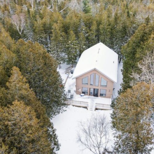 Aerial view of the private chalet nestled among snow-covered trees