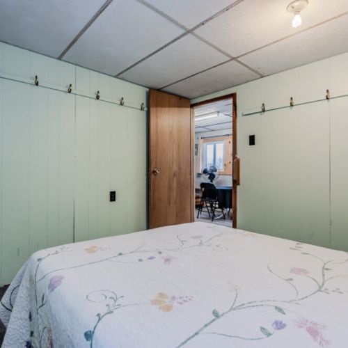 A convenient setup with hooks for hanging items, adding functionality to the bedroom space.