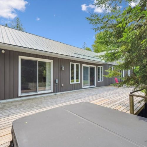 Step out onto the spacious back deck and enjoy the year-round private hot tub, surrounded by the peaceful forest setting.