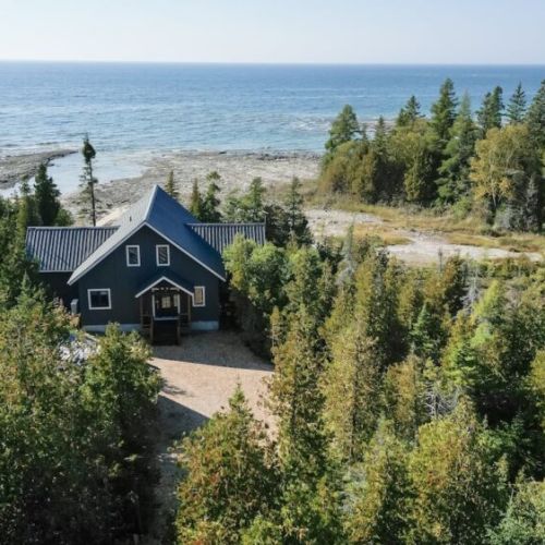 Private lakefront retreat—nestled among trees with stunning Lake Huron views.