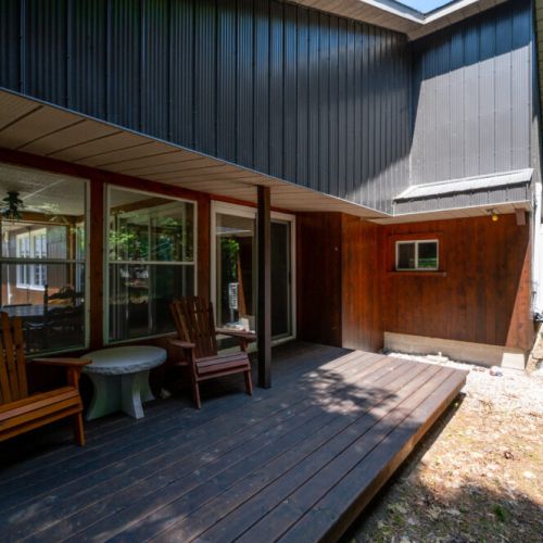 Relax on the covered porch, a shaded haven ideal for enjoying the fresh, pine-scented air and the peaceful rustling of leaves. A perfect spot to do some reading or relaxing with a cup of coffee.