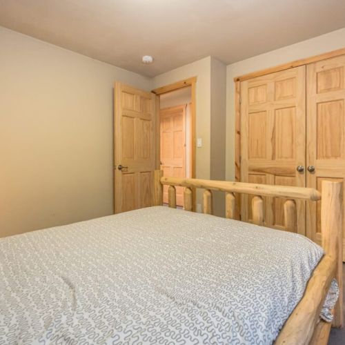 Main floor Guest bedroom with closet space. A straightforward bedroom setup that offers a relaxing space to unwind after a day of Tobermory adventures.