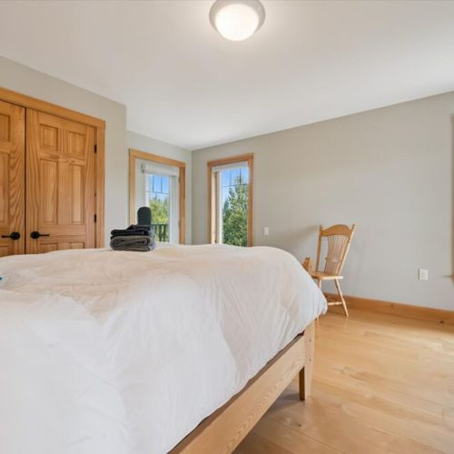 Bedroom 1: Comfortable bedroom retreat featuring warm wood finishes and peaceful views.