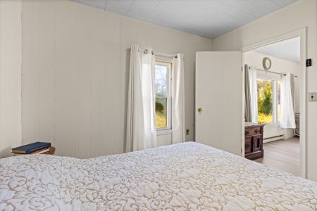 Wake up to peaceful country views and natural light from this comfortable main-floor bedroom.
