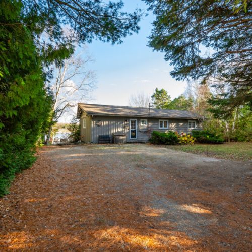 The front yard boasts plenty of space for parking, ensuring convenience and ease for you and your guests.