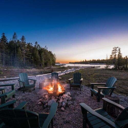 Sunset campfires by the water create the perfect cottage getaway atmosphere.