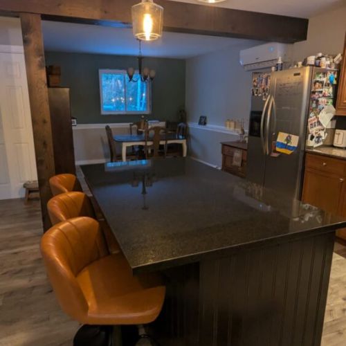 Spacious kitchen island with bar seating and modern lighting, perfect for casual meals and conversation.