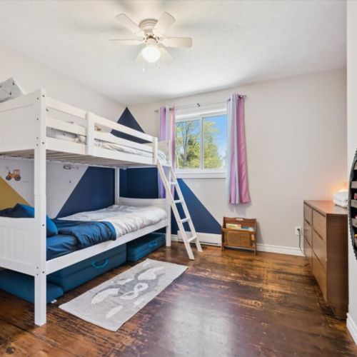Bedroom 2: Fun bunk bed room perfect for kids, featuring a double bed below, twin above, and playful décor.